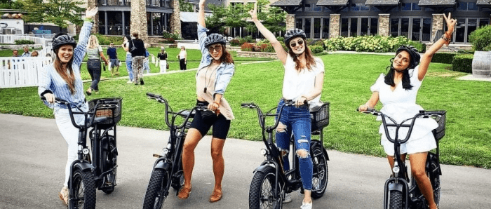 ladies on bike with one hand up